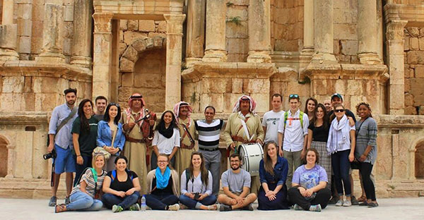 group of people in front of old architecture
