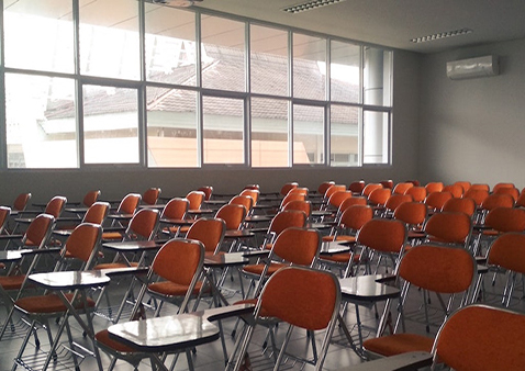 an empty classroom with desk chairs