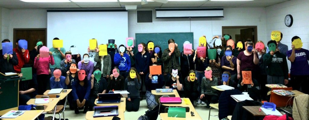 classroom full of students wearing paper masks