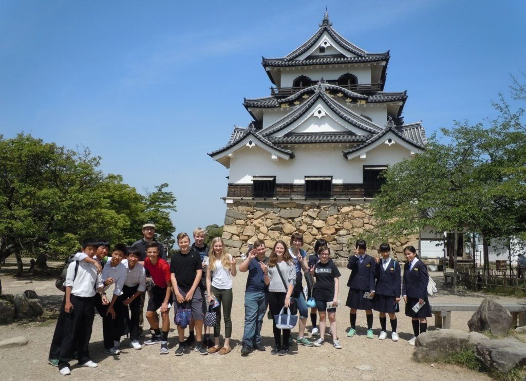 Elias Young's classmates standing outside in front of Hikone Castle in Japan. 