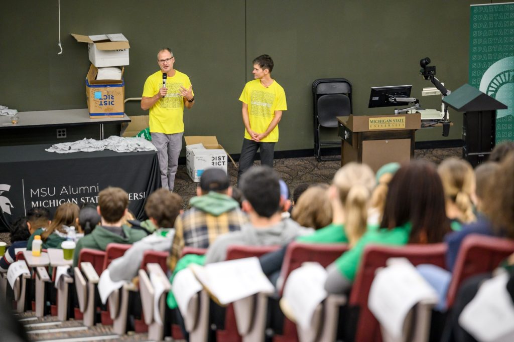 Josh Kilmer-Purcell and Dr. Brent Ridge wearing the Beekman 1802 Kindness T-shirts as they talk to a group of Michigan State University students.