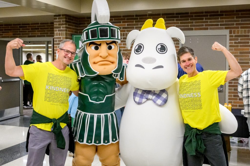 Josh Kilmer-Purcell and his husband, Dr. Brent Ridge, flex their arms with Sparty and the Beekman 1802 goat mascot.