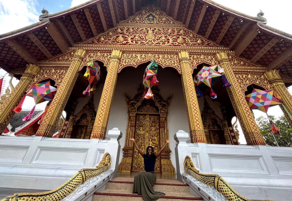 Kaylah Jetton sits in front of a temple in Laos.