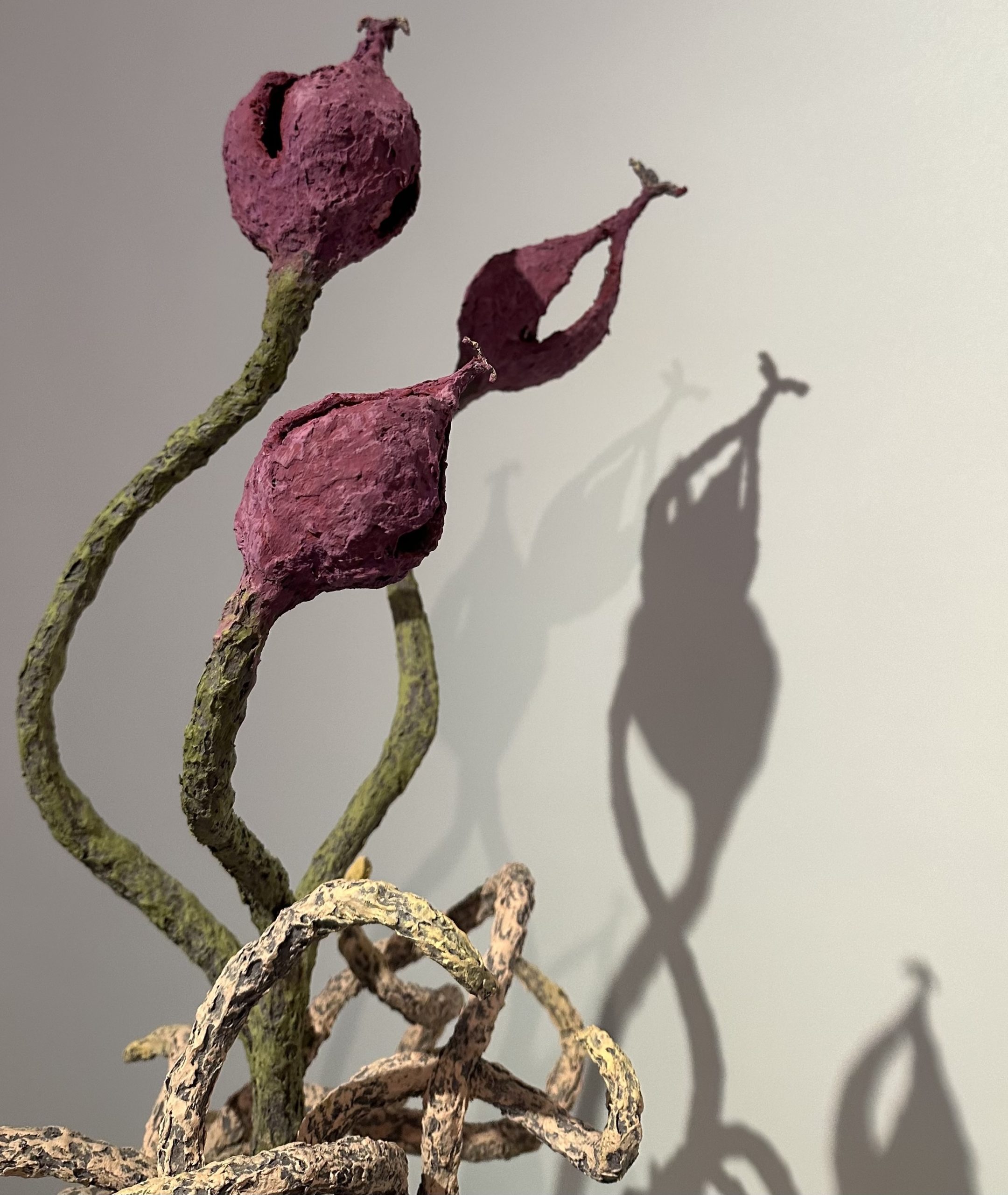 Close-up photo of Mackenzie Sheehan-D'Arrigo's sculpture of a budding plant walking on its roots.