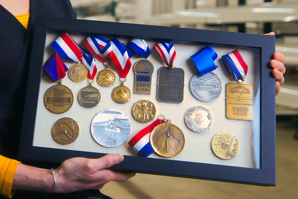 Kelly Salchow MacArthur, a two-time Olympic rower and graphic design professor at Michigan State University, holds a small display box with her most cherished medals from her time as an elite athlete in rowing.