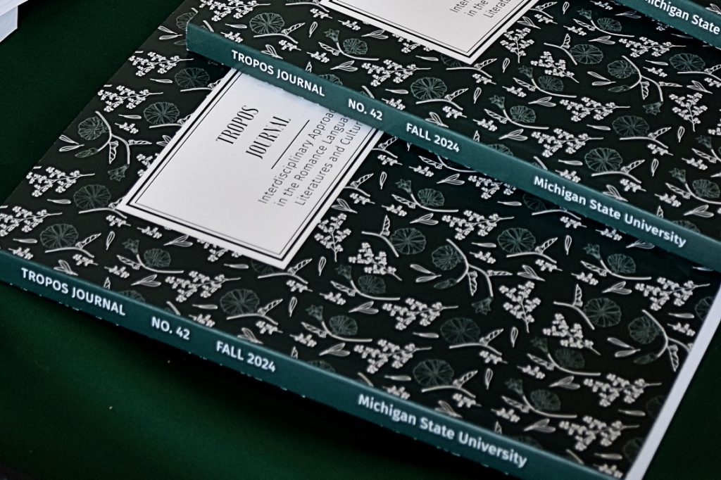 A photo of a couple copies of the TROPOS journal NO. 42, Fall 2024 edition, which has a dark green cover. 