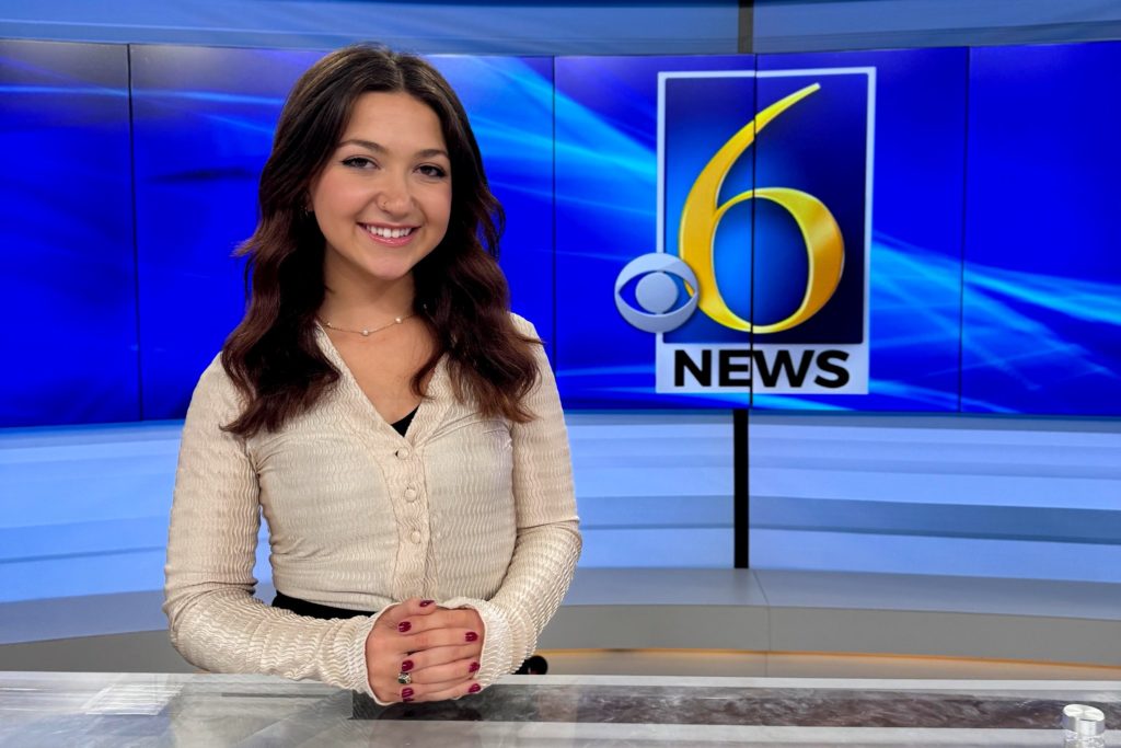 A woman with long brown hair sitting at the anchor desk for WLNS Channel 6 and behind her is the "6 News" graphic. 