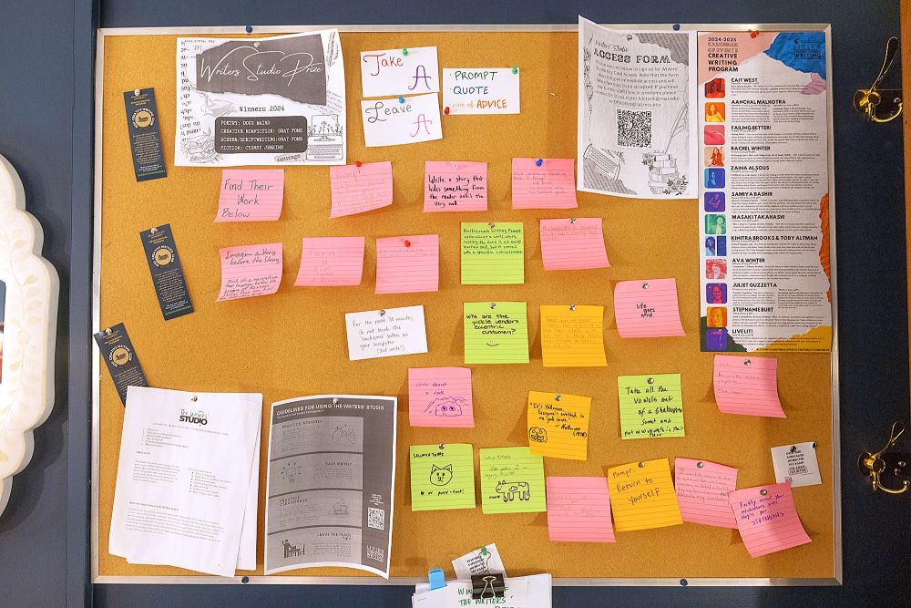 A corkboard of event flyers and writing prompts on Post-It notes.