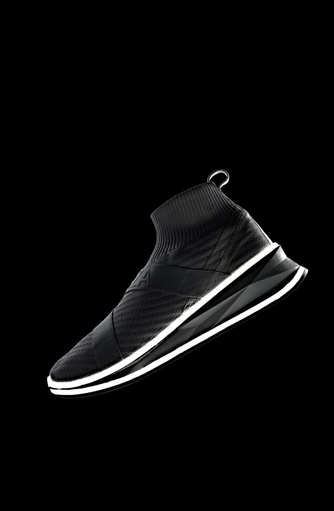 A sleek, futuristic black sneaker with white lines near the sole. The shoe is isolated against a black background.